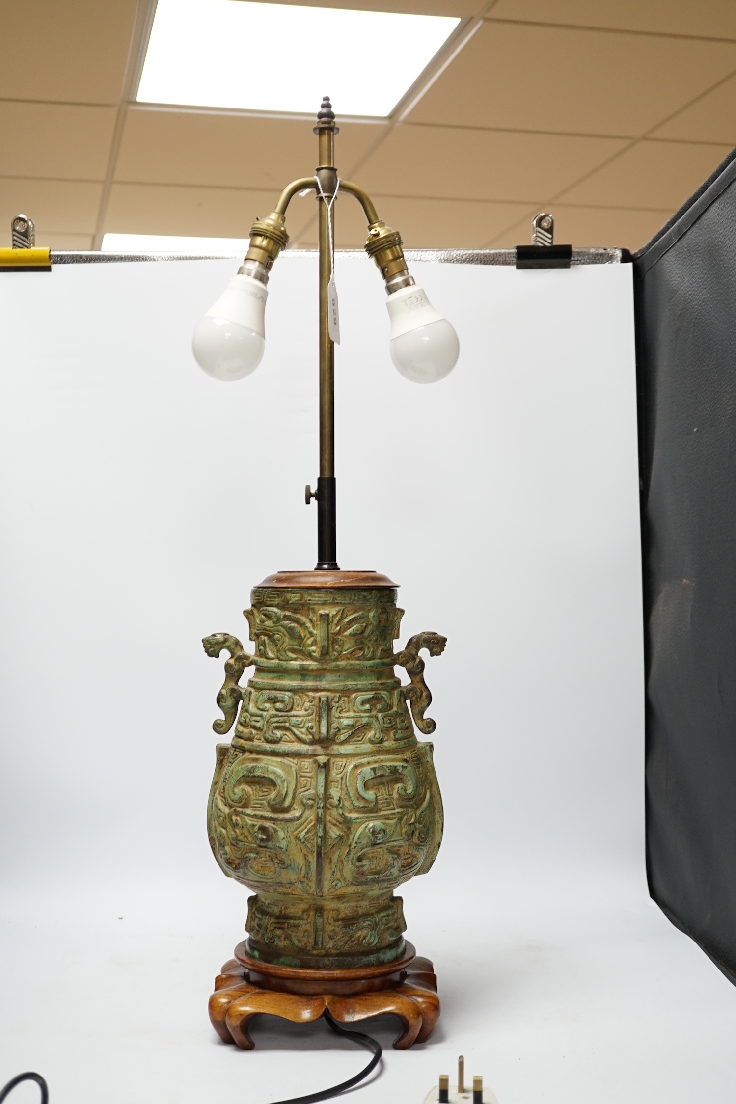 A Chinese archaistic bronze table lamp on stand 36cm high